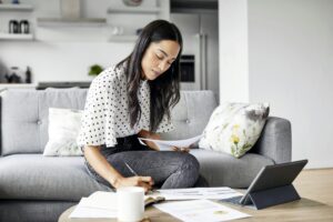 woman at home calculating and managing debt