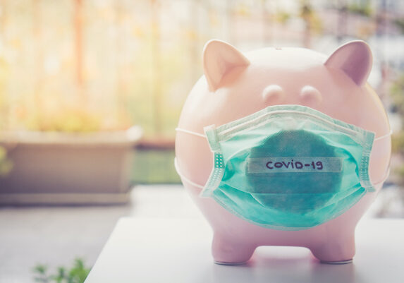 Piggy bank with Face Mask, Financial crisis and market crash due to virus spread.